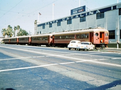 1961 Photo of cars in front of Train at rail station