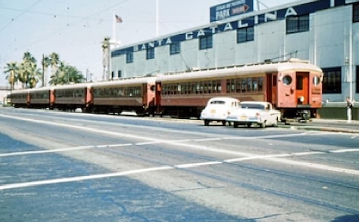1961 Photo of cars in front of Train at rail station